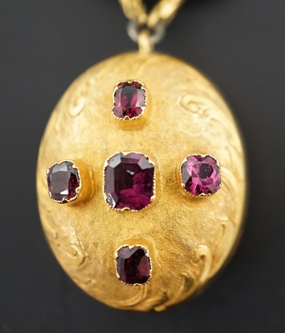 A Victorian textured gold and garnet cluster set drop 'knot' brooch